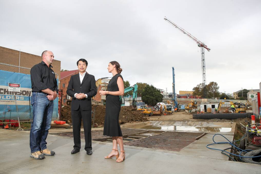 WORKS: Shane Wilson, project manager for Hutchinson Builders with Alex Lei from developers BRDB and Holly Charters from Colliers. Picture: Adam McLean