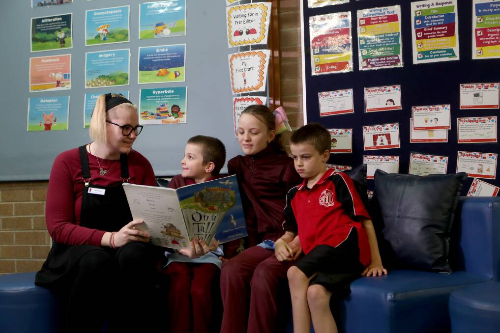 HELPING HAND: Volunteer Athena Withnall with students Jake Maher, Shakira Cuzner and Jai Maher at Mount Warrigal Learning Club. Picture: Sylvia Liber