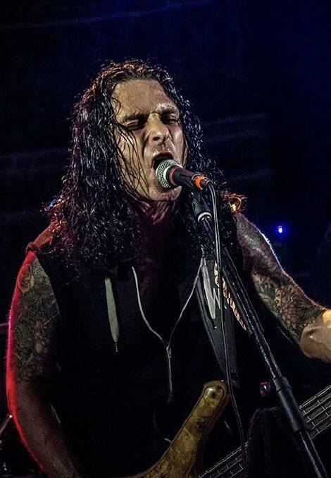 (Left) Founding front-man Chris Rand performing with veteran metallers Segression at the Wollongong UniBar in 2016. Picture: Brendan Delavere