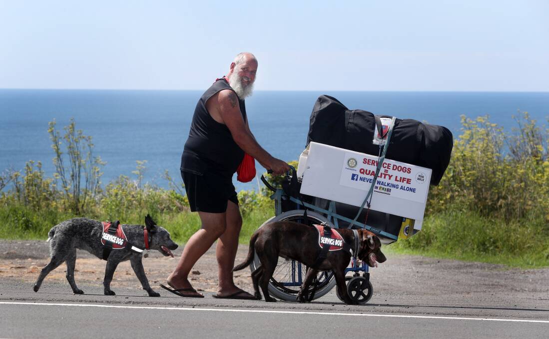 WALKING FOR A CAUSE: Andrew McGowan walking along Lawrence Hargrave Drive with his dogs Hay Zeus and Essie Girl. Picture: Robert Peet