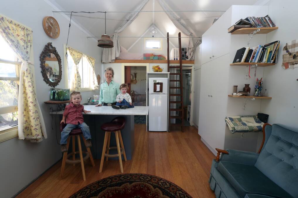 Jhettaya Warner with her children Beau, two, and Red, one, in their tiny home based at the family property in Jamberoo. 