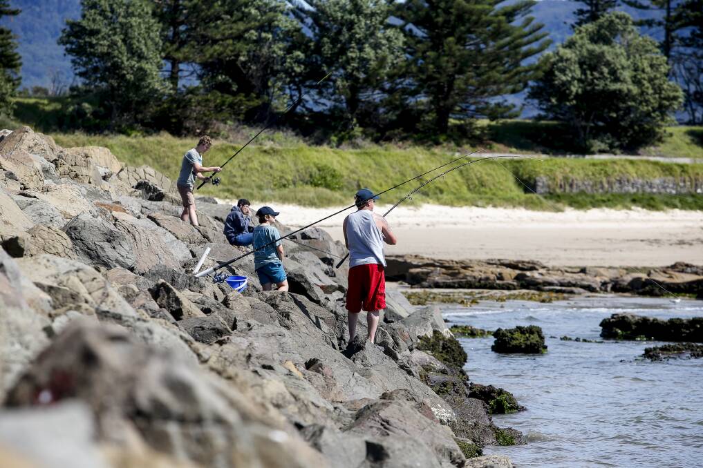 People fishing near the boat ramp at Bellambi. Picture: Anna Warr