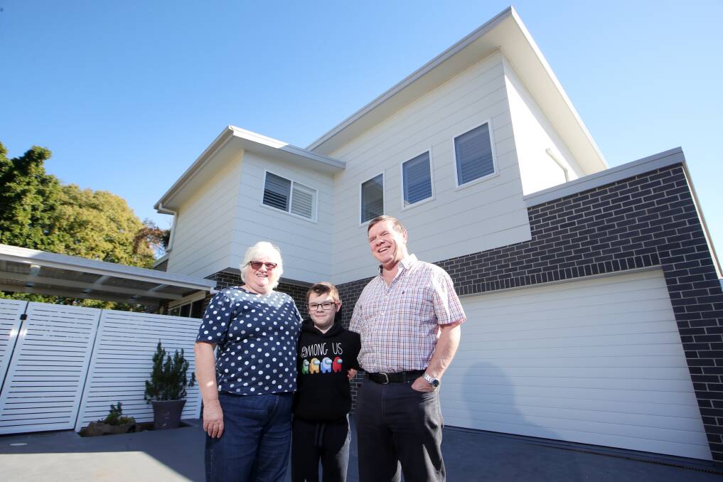 NEW HOME: Sue Beaver and John Beaver, pictured with grandson Lewis Dellow, at the townhouse they recently bought in Oak Flats. Picture: Sylvia Liber 