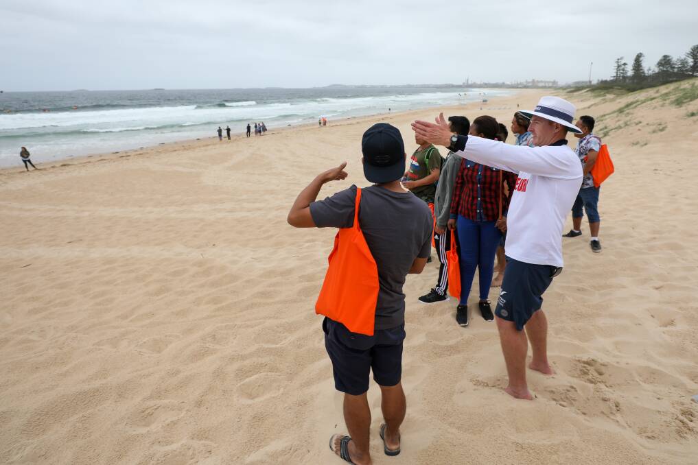 HELPING: Council lifeguard Tim Jennett during a recent water safety course for people from culturally diverse backgrounds at City Beach. Picture: Adam McLean