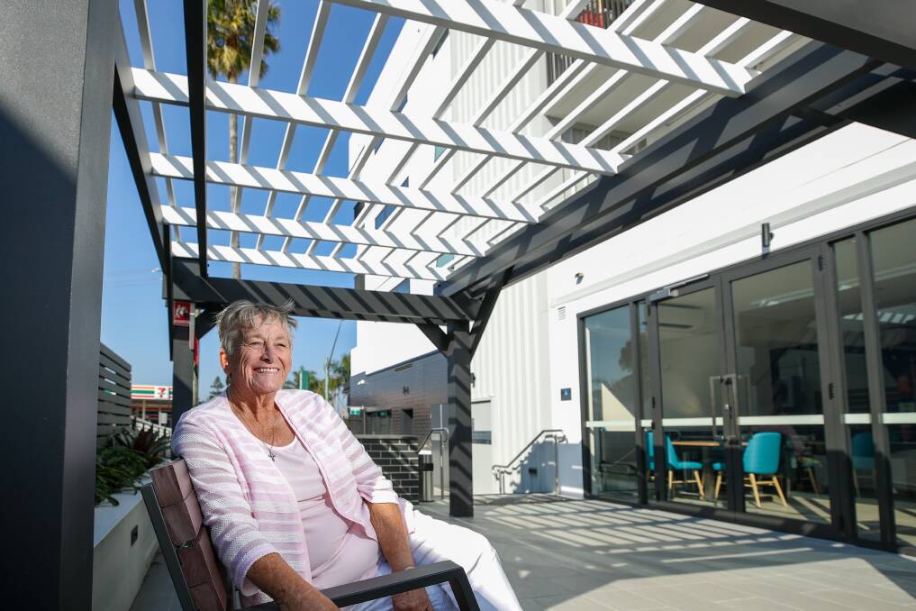 AT HOME: Kerry North relaxes in the communal courtyard area of the affordable housing block where her rent is subsidised by Anglicare. Picture: Adam McLean