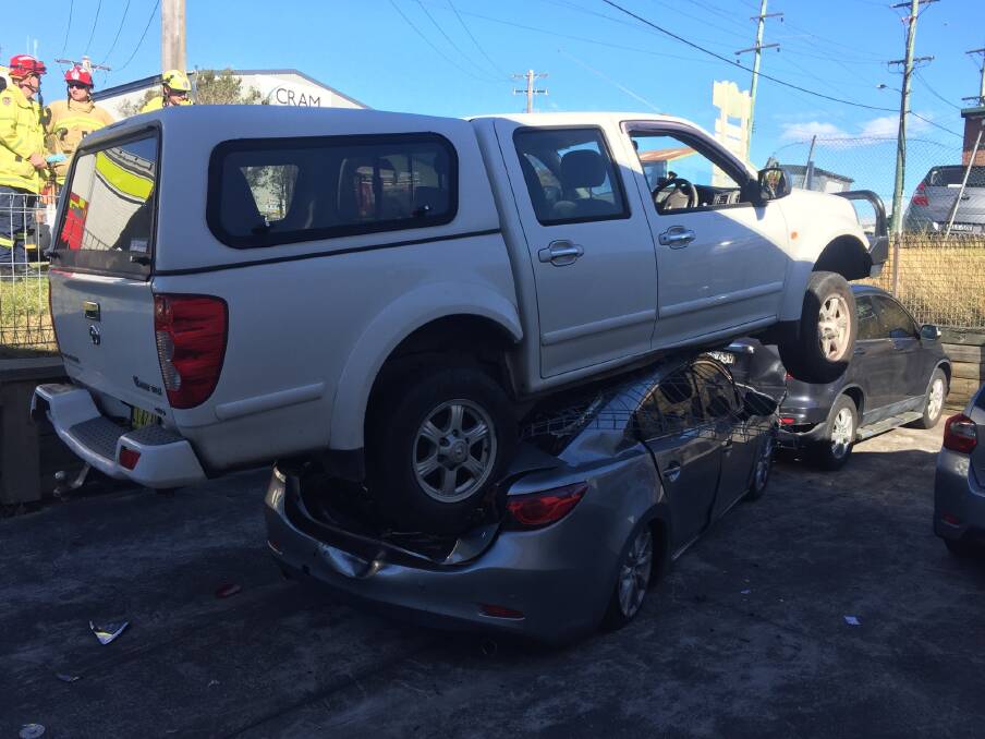 Twin cab lands on roof of a car at Unanderra