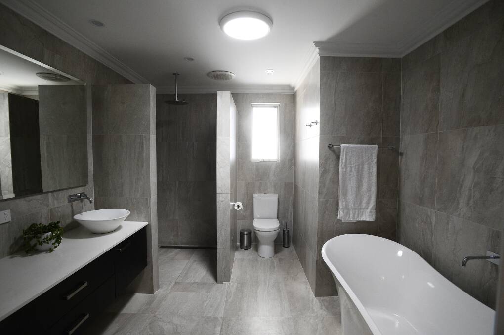 WORKS: A renovated bathroom featuring floor to ceiling tiling. Do you have an interesting real estate story that could be featured in an upcoming edition? Please email brendan.crabb@illawarramercury.com.au with details. 