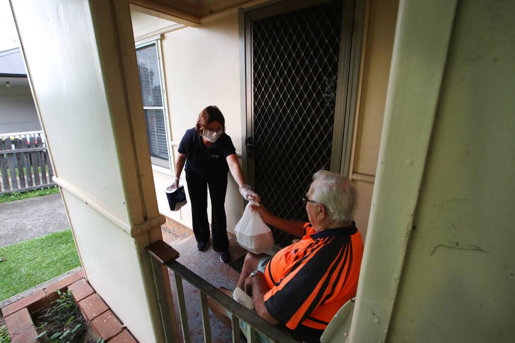 KEY SERVICE: Volunteer Vanessa Child delivering to client John Carter in Wollongong on Monday. Picture: Sylvia Liber