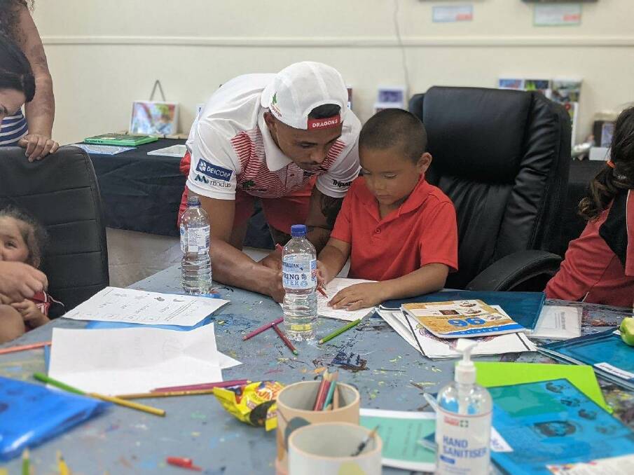 LEARNING: St George Illawarra Dragons player Jayden Sullivan with a student at the learning club celebration on Monday. Picture: Supplied