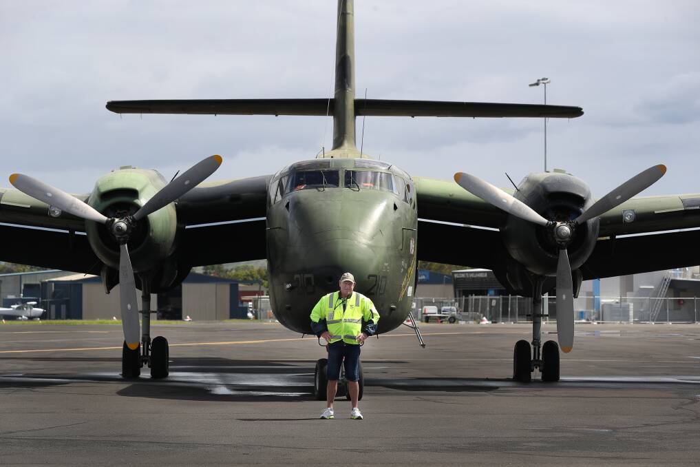 TARMAC DAYS: HARS volunteer John Croll standing in front of a RAAF transport de Haviland Caribou on Friday. Picture: Robert Peet