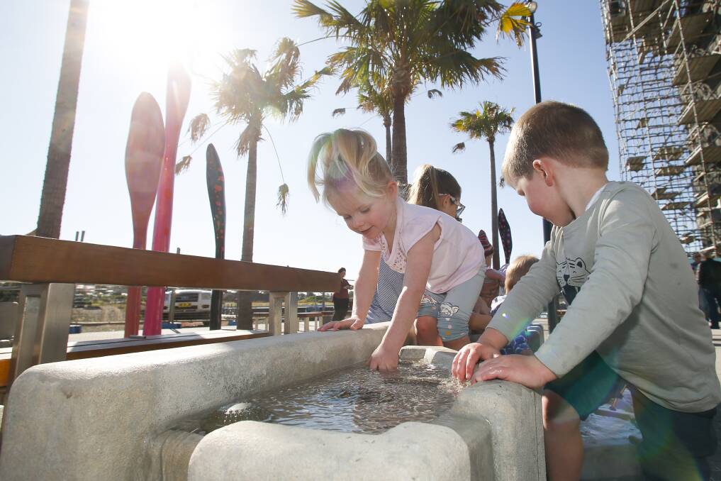 ACTIVITY: Two-year-old Isabelle Barrows and three-year-old Tom Barry exploring the interactive water feature at Shell Cove. Picture: Anna Warr