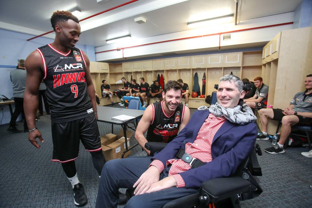 Dr Justin Yerbury with Hawks players Cedric Jackson and Kevin White. Picture: Adam McLean
