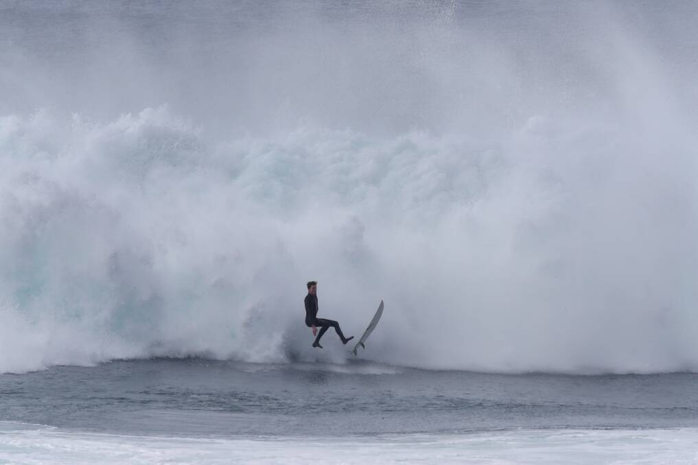 April 11: Big swells generated by offshore winds pounded the Illawarra coastline with surfers ignoring warnings to stay out of the water and instead taking the chance of being slammed and pulled deep underwater.