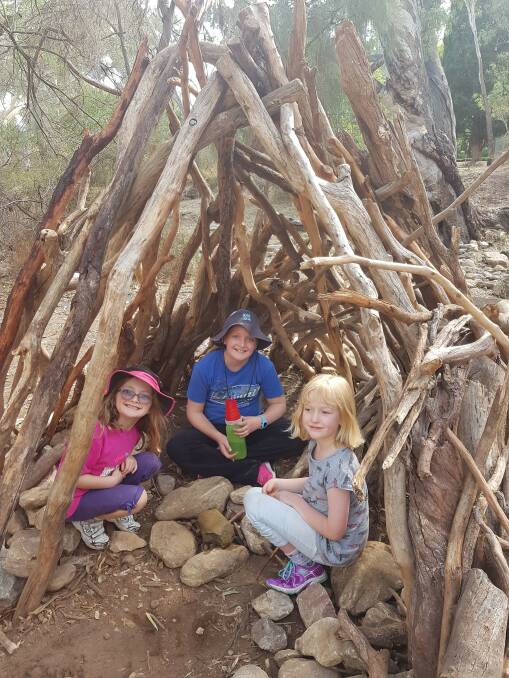 Jasmine Crisp, 10, Amelia Crisp, 6, and Eleanor Kosters, 8, building fully sanctioned bush cubbies. Photo: Therese Kosters