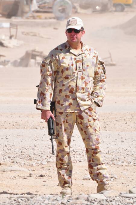 Glenn Kolomeitz, a lawyer and former soldier who served in Afghanistan and East Timor, on deployment (left and below) and in his office in 2013 ahead of contesting a seat in the Senate (above).
