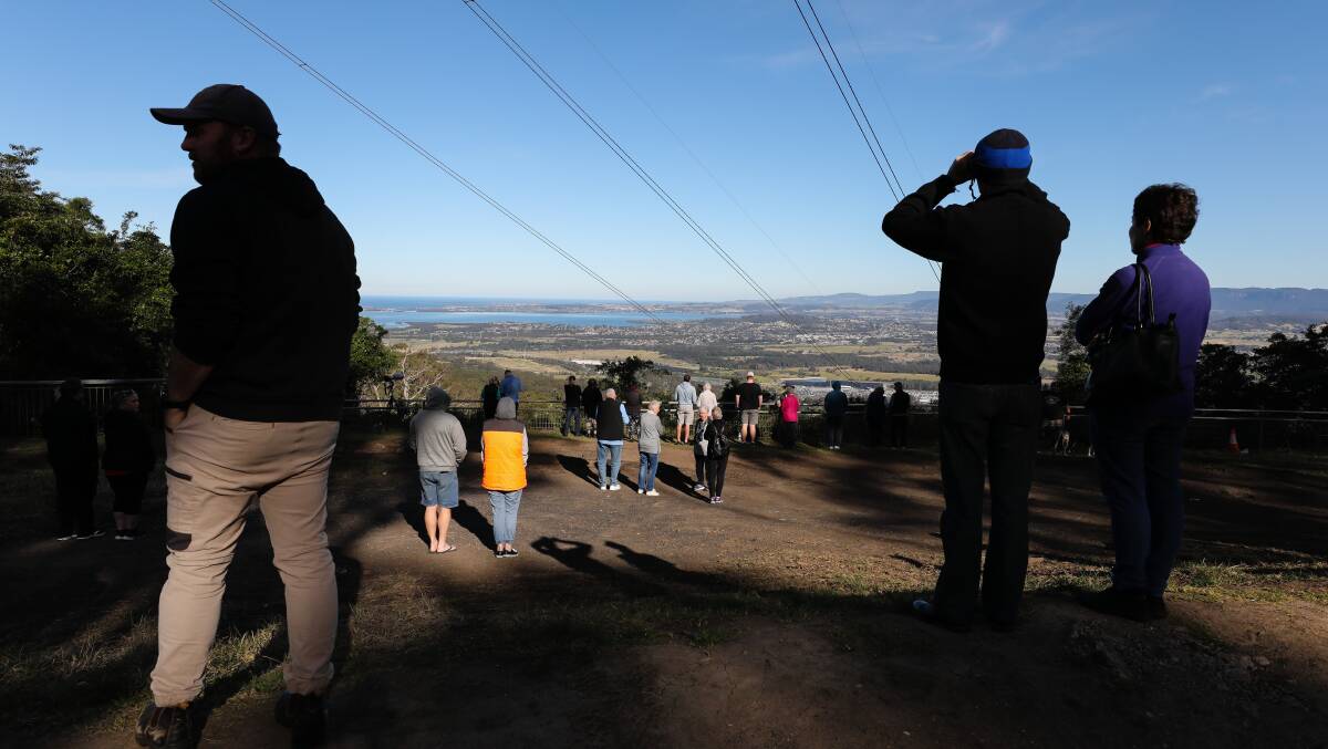 Crowds gather at Mount Keira to watch the historic flyover. Photo: Adam McLean