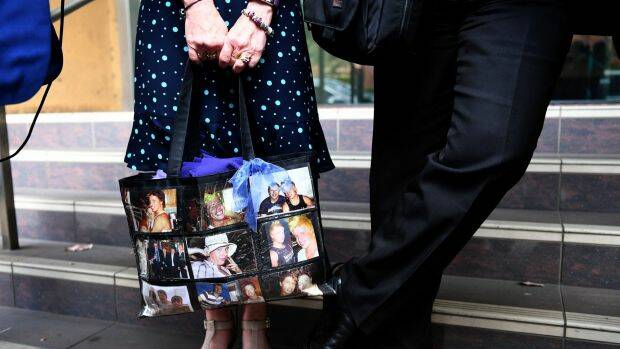 Faye Leveson carries a bag with images of her son as she arrives at the coronial inquest on Tuesday.  Photo: AAP
