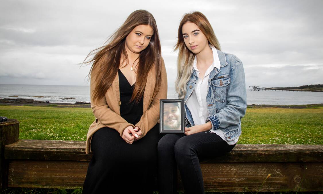 Sisters Maddison and Taylah McQuade with a picture of their father Leigh McQuade who recently died by suicide. Picture: Georgia Matts 