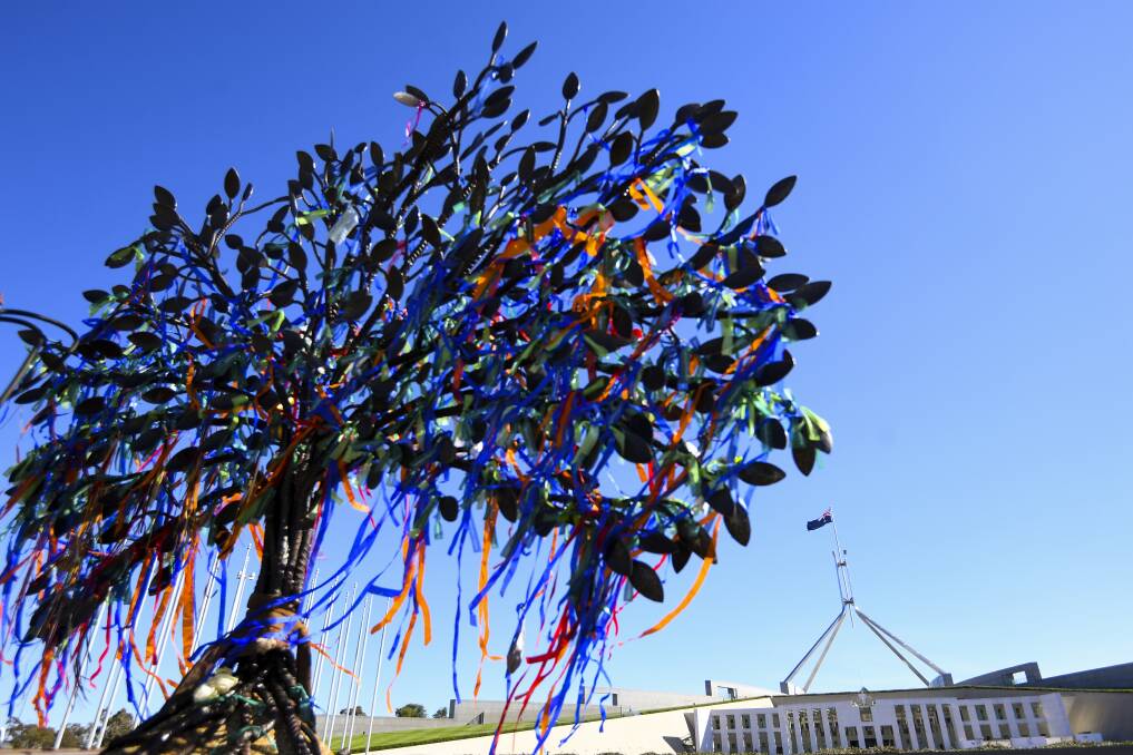 A memorial tree sculpture outside Parliament House in Canberra on Monday. Photo: Lukas Coch, AAP