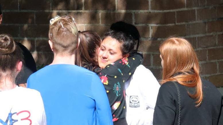 Nikita Campbell (facing camera) hugs friends and family after being granted bail in August last year.