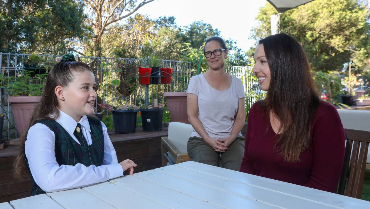 Kiara Perizi is greeted by a grateful Illawarra Women's Health Centre manager Sally Stevenson and community liaison/client support manager Miranda Batchelor after raising $1000 on her birthday. Picture: Adam McLean.