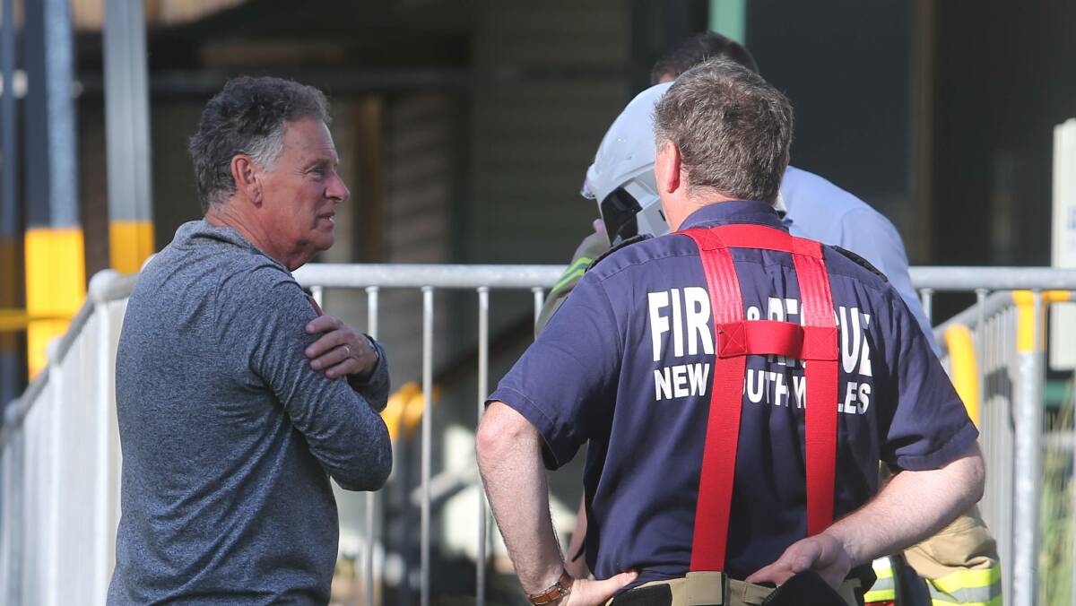 Corrimal High Deputy Principal Ross Graham speaks with a fire fighter. Photo: Robert Peet