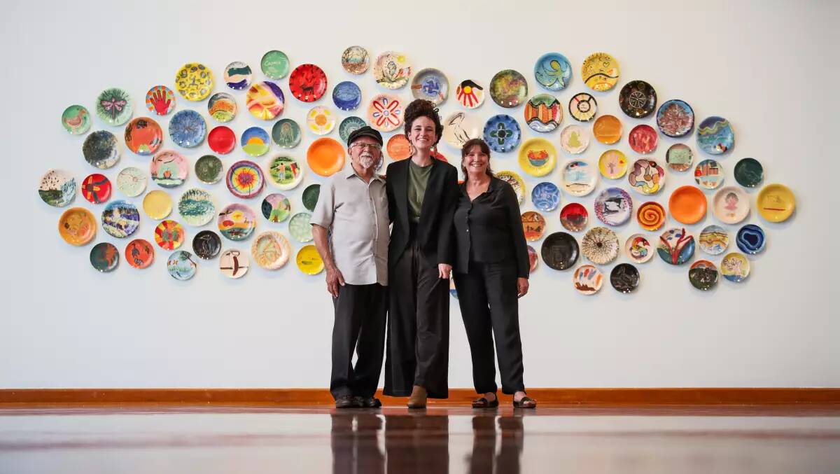 Exhibition curator Tess Allas, right, with Uncle Vic Chapman and Alinta Maguire in front of 'Love Letters to Coomaditchie' in 2023. 