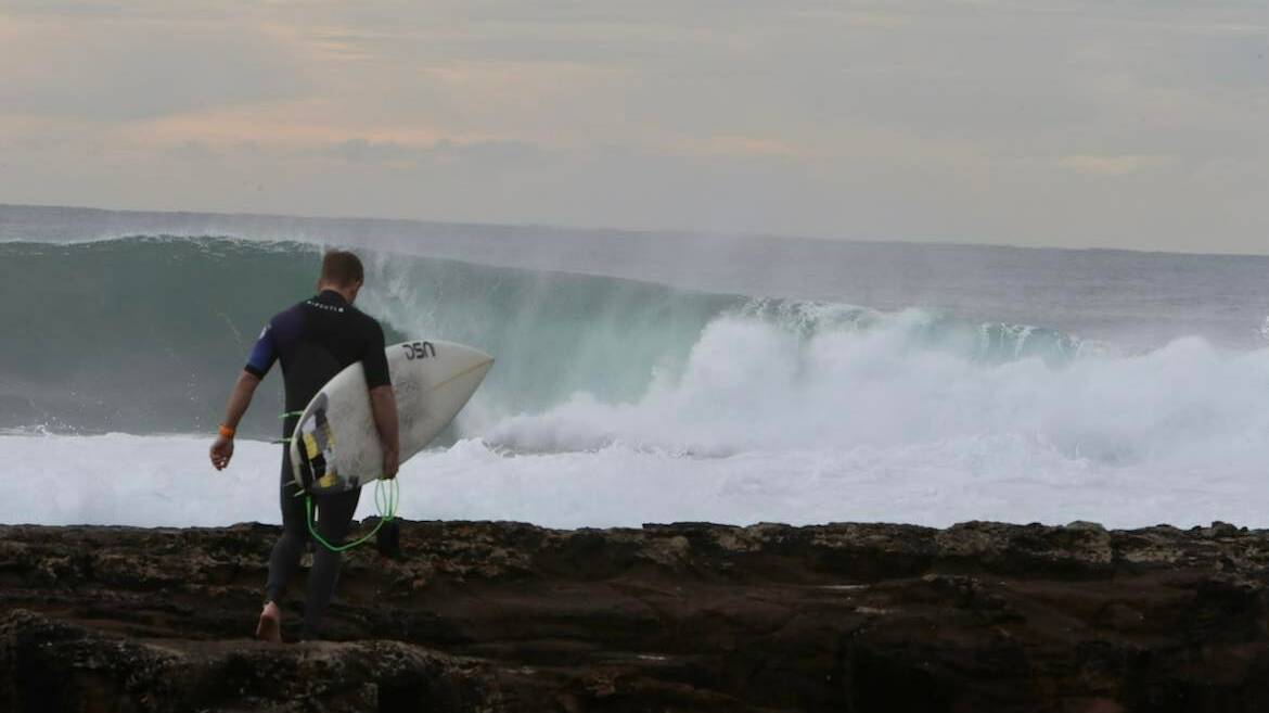 Surfers hit the surf at Shellharbour, where six-foot waves have been reported on Friday. Photos: Sylvia Liber