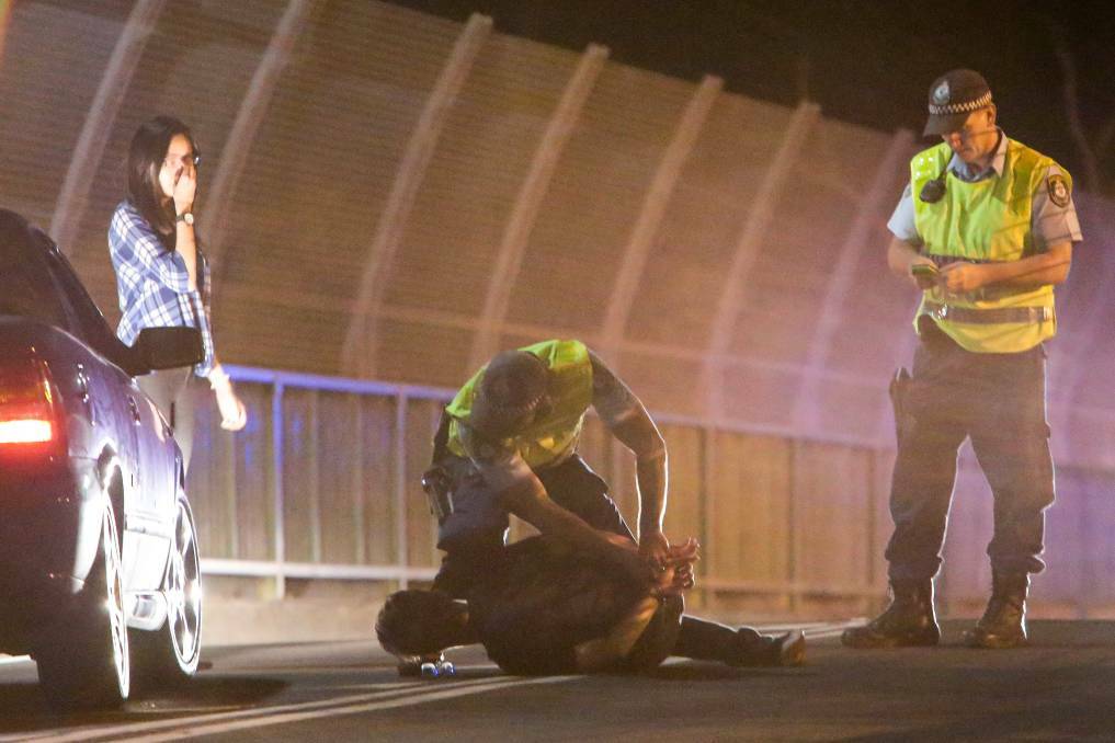A man is arrested after a police constable was hit by a car at a roadblock on Gipps Road at Gwynneville on Saturday night. Picture: Adam McLean
