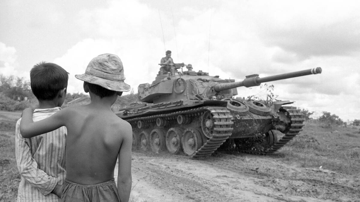 1970: Vietnamese children watch a Centurion tank swing off the highway to support Australian and New Zealand infantry. Picture: John Fairley, courtesy AWM FAI/70/0419/VN.