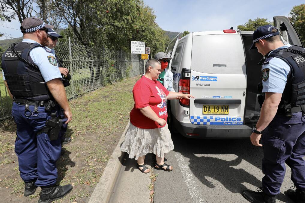 Dapto grandmother Sam Noonan is arrested after chaining herself by the neck to the front gate of Russell Vale mine on Tuesday morning. Picture: Adam McLean