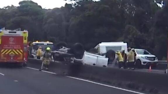 Traffic heavy after car towing caravan crashes and flips on Mount Ousley