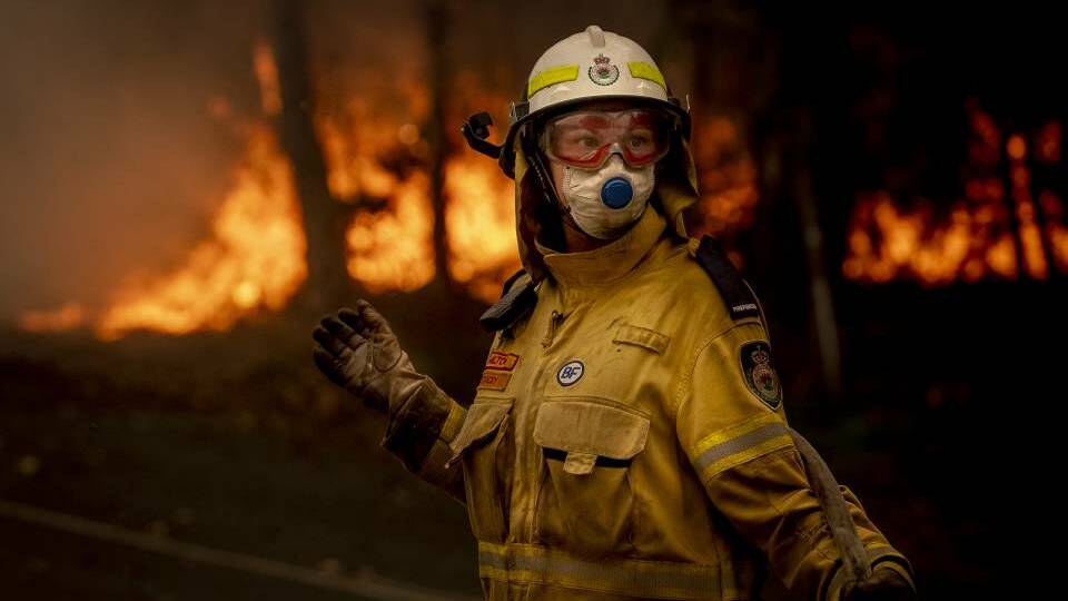  A NSW Rural Fire Service volunteer works to battle a bushfire on Murramaranf Road in Bawley Point on Thursday afternoon. Picture: Sitthixay Ditthavong 