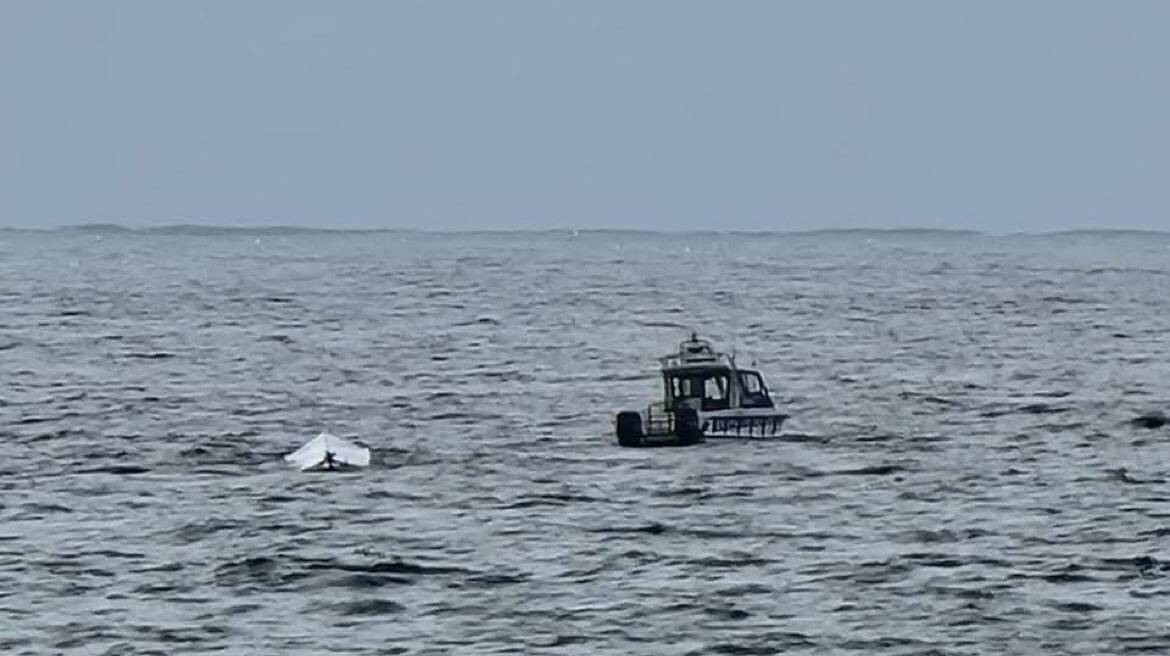 The capsized boat off Bulli Beach on Sunday. 