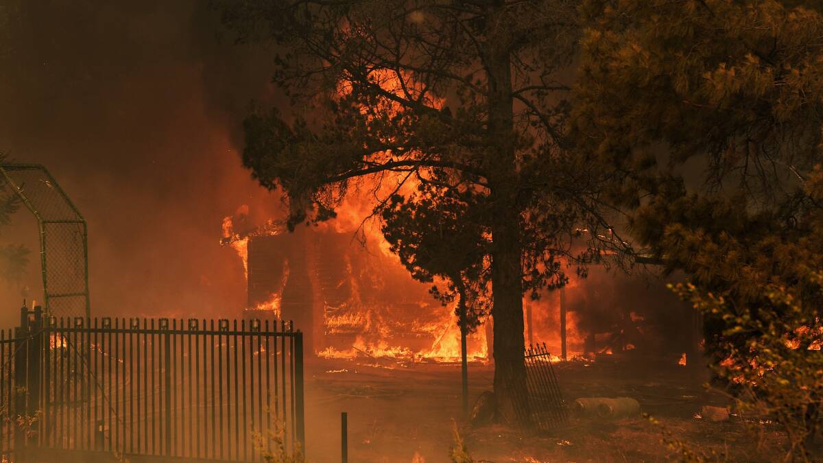 A RFS fireman in front of Mr Webb's house, which could not be saved from the fire on the outskirts of Bargo last Thursday. Photo: Kate Geraghty, Sydney Morning Herald