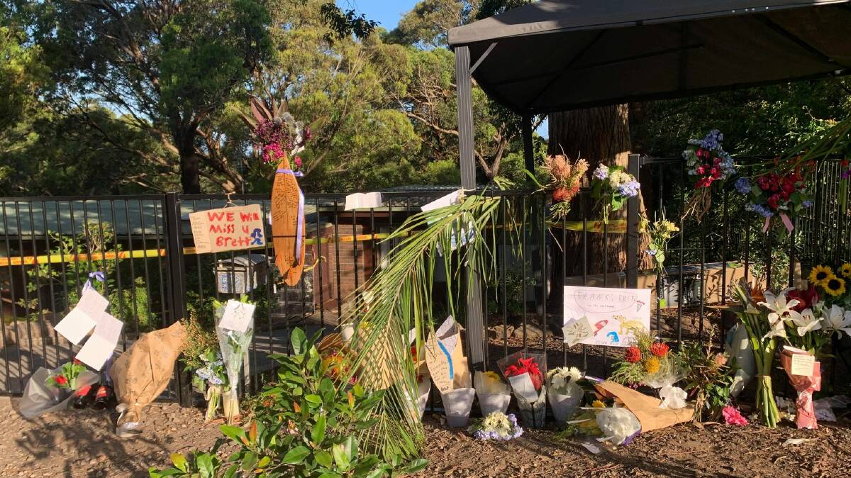 The memorial which has taken shape outside Mr Harris's house off Lawrence Hargrave Drive. Picture: Luke Shanahan.