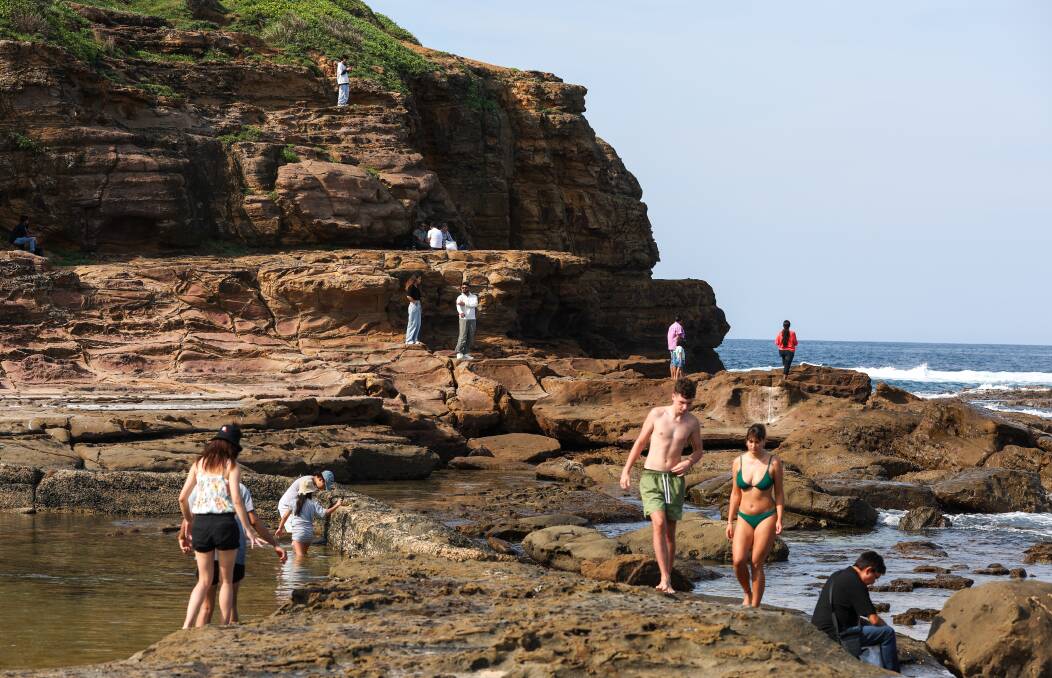 Beachgoers climb the rocks near City Beach. Picture by Adam McLean