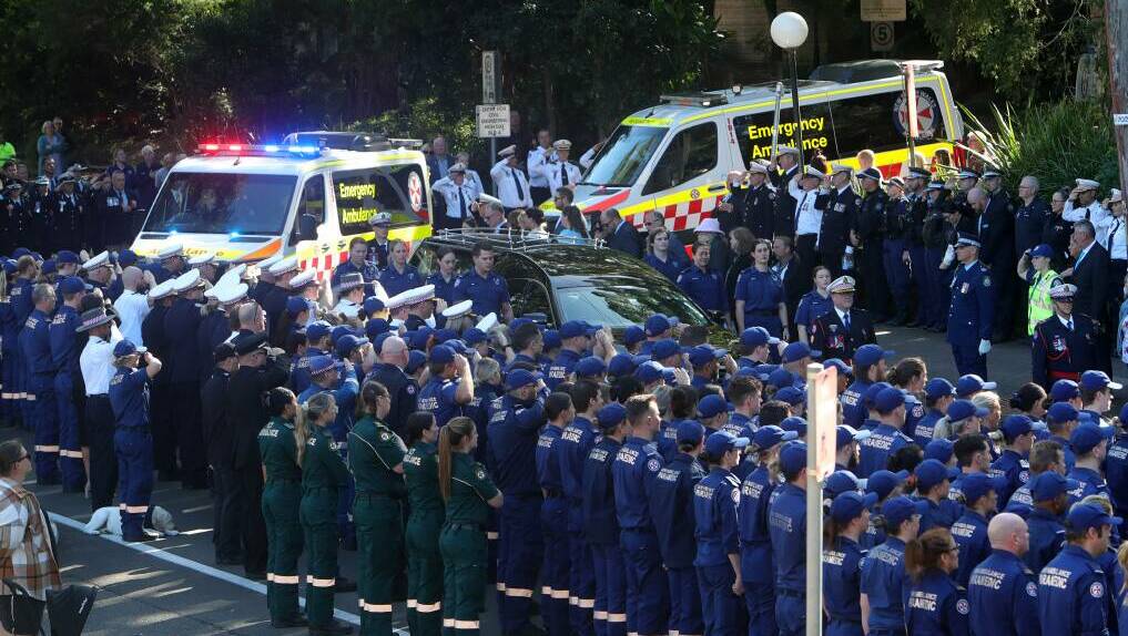Emergency services personnel form a guard of honour at Steven Tougher's funeral.