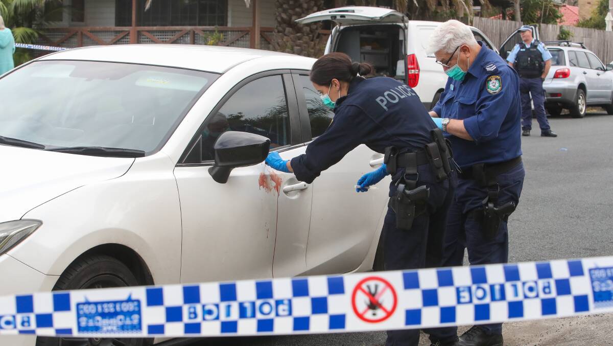 Forensic police collect evidence after the stabbing in East Corrimal. Photos: Adam McLean