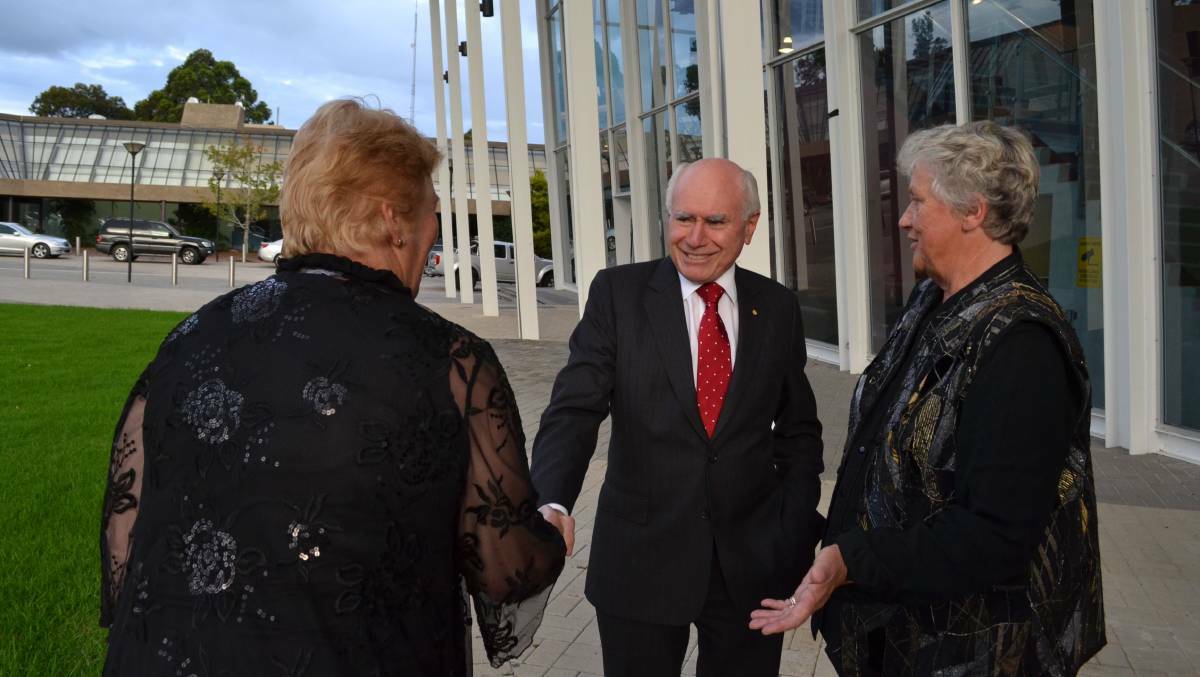 Member for Gilmore Ann Sudmalis and former member Joanna Gash greet former prime minister John Howard in 2014.