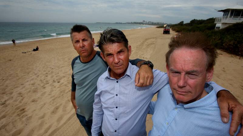 Brothers Stephen Grimmer, Paul Grimmer and Ricki Grimmer in 2016 at Fairy Meadow Beach. Picture: Robert Peet
