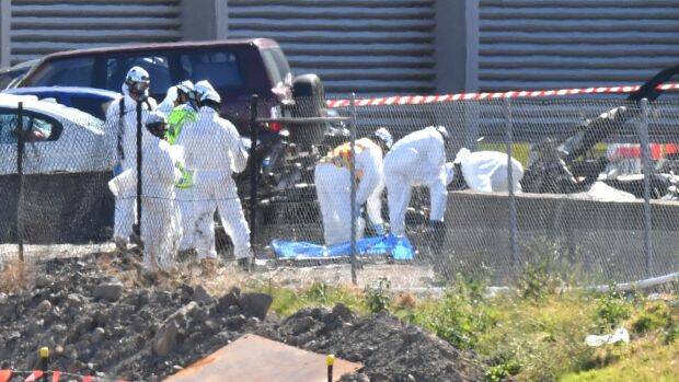 Investigators at the site of the plane crash. Photo: Joe Armao, Fairfax Media.
