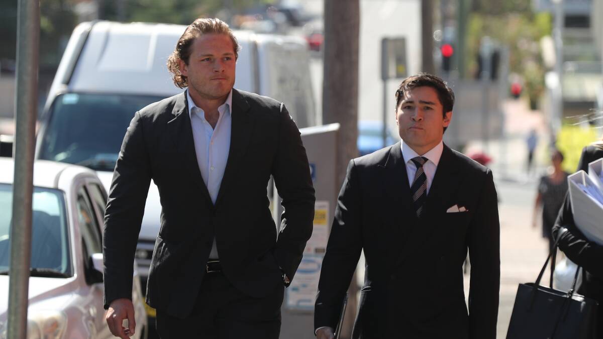 Dragons player George Burgess with his lawyer at Wollongong courthouse on Tuesday. 