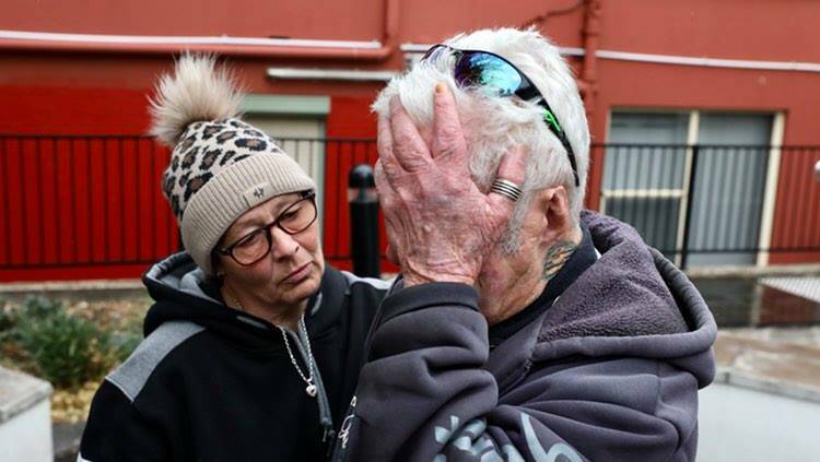 Nathan Costello's father, Robert, is comforted by his daughter-in-law Louisa Kinchela outside Wollongong court on Thursday. 