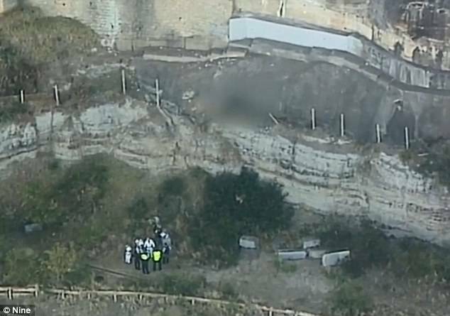 Rescue crews near the base of the cliff where a 24-year-old man fell to his death. Photo: Nine Network

