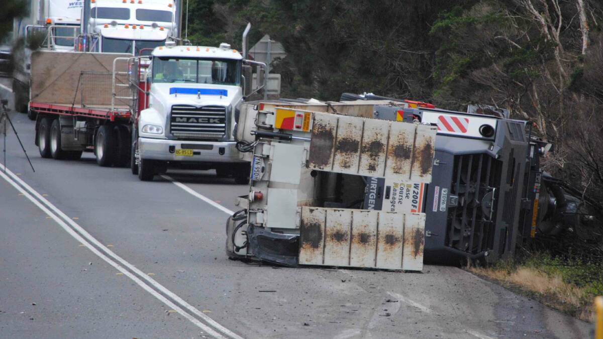 The truck, carrying an asphalt removal machine, in Thursday morning's crash rolled and came to rest on its side. Photo: Damian McGill