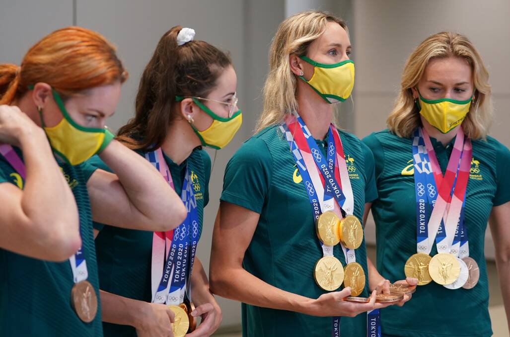 Emma McKeon, second from right, with her swag of medals. Photo: AAP