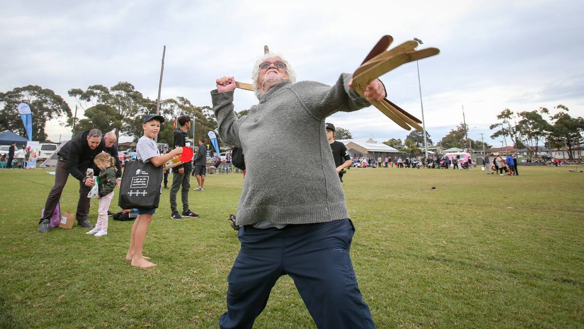 Uncle Laddie Timbery of Huskisson showing children how to throw a boomerang at the NAIDOC Community Day at Albion Oval, in Albion Park. Photo: Adam McLean
