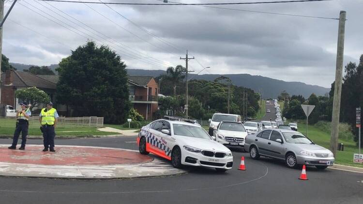 Police help direct traffic on Campbell and Carrington streets in Woonona.
