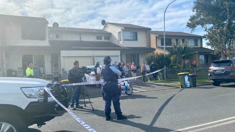 Police cordon off a section of Robert Cram Drive in Wollongong. 